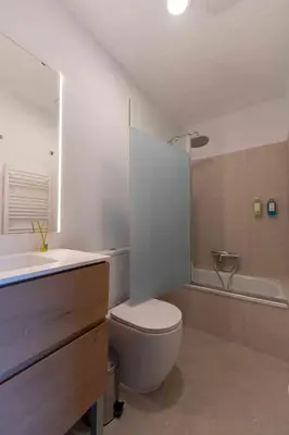 a bathroom with a toilet and a sink and a tub at Reverence Villas Fufin in Monterroso