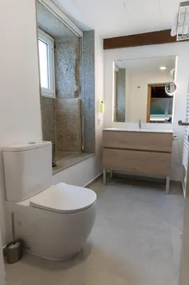 a bathroom with a toilet and a sink at Reverence Villas Fufin in Monterroso
