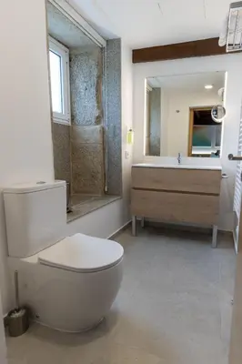 a bathroom with a toilet and a sink at Reverence Villas Fufin in Monterroso