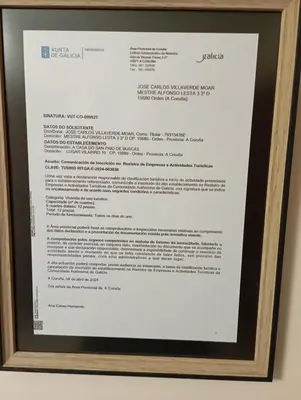 a picture of a certificate in a frame on a wall at A Casa do San Paio de Buscás in Ordes