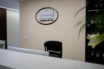 a black chair in an office with a sign on the wall at A Quinta de Cea in Cea