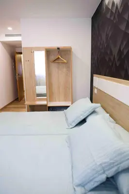 a bedroom with a large bed and a closet at A Quinta de Cea in Cea