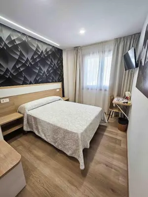 a bedroom with a large bed in a room at A Quinta de Cea in Cea