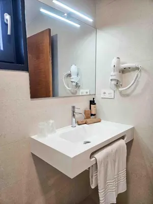 a bathroom with a white sink and a mirror at A Quinta de Cea in Cea