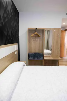 a bedroom with a white bed and a mirror at A Quinta de Cea in Cea