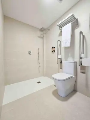 a white bathroom with a toilet and a shower at A Quinta de Cea - Apartamentos in Cea