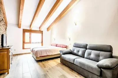 a living room with a couch and a bed at Cosy Apartment with Mountain View in Mourisca - 65 sqm in Morisca