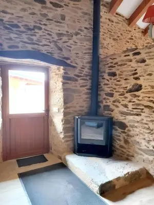 a stone walled room with a fireplace and a door at Cosy Apartment with Mountain View in Mourisca - 65 sqm in Morisca