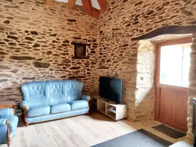 a living room with a blue couch and a tv at Cosy Apartment with Mountain View in Mourisca - 65 sqm in Morisca