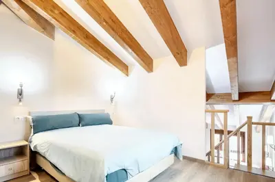 a bedroom with white walls and wooden beams at Cosy Apartment with Mountain View in Mourisca - 65 sqm in Morisca