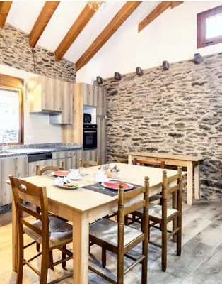 a kitchen and dining room with a wooden table and chairs at Cosy Apartment with Mountain View in Mourisca - 65 sqm in Morisca