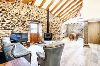 a living room with a stone wall at Cosy Apartment with Mountain View in Mourisca - 65 sqm in Morisca