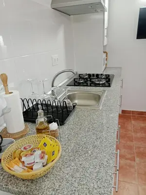 a kitchen counter with a sink and a tray of dishes at Casa turística Lirio in Chandreja