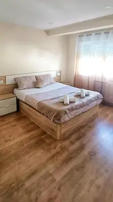 a bedroom with a large bed with a window at TERRA DE AUGAS II in Caldas de Reis