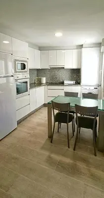 a kitchen with a table and chairs and appliances at TERRA DE AUGAS II in Caldas de Reis
