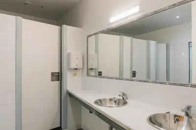 a bathroom with two sinks and a large mirror at Vila Vilariño Albergue Hotel & Restaurante in Ourense