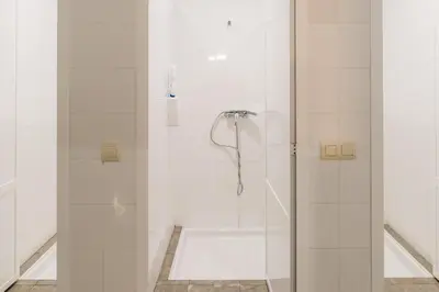 a shower with a glass door in a bathroom at Vila Vilariño Albergue Hotel & Restaurante in Ourense