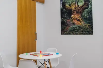 a table with chairs and a picture of a tree at Vila Vilariño Albergue Hotel & Restaurante in Ourense