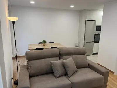 a living room with a couch and a table at Apartamento con Encanto in Santiago de Compostela