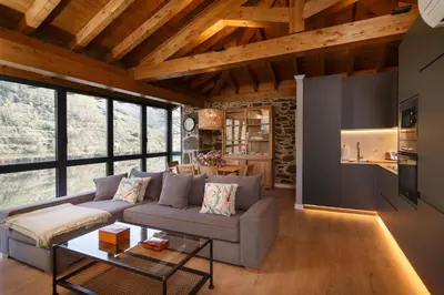 a living room with a couch and a table at Ribeira Sacra a Orilla Rio Miño Casas do Pincelo in Pincelo