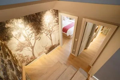 a bedroom with a mural of trees on the wall at Ribeira Sacra a Orilla Rio Miño Casas do Pincelo in Pincelo