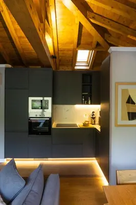a living room with a couch and a kitchen at Ribeira Sacra a Orilla Rio Miño Casas do Pincelo in Pincelo