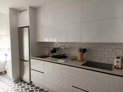 a kitchen with white cabinets and a counter top at Vivienda Arias in Carballino