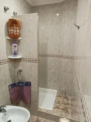a small bathroom with a shower and a sink at Vivienda Arias in Carballino