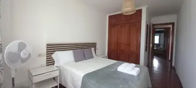 a small bedroom with a bed and a fan at O Portiño de Sigueiro # a 10 min de Santiago in Sigüeiro