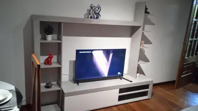 a tv in a tv stand with a tv at O Portiño de Sigueiro # a 10 min de Santiago in Sigüeiro