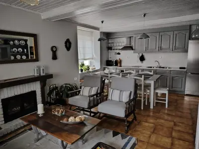 a kitchen and living room with a table and chairs at Casa Alba in Chan de Vilar
