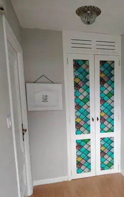 a closet with colorful glass doors in a room at Casa Alba in Chan de Vilar