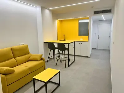 a person sitting on a swing in a room with two beds at Pension Sarria in Sarria
