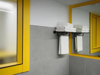 a bathroom with a shelf with towels and a mirror at Pension Sarria in Sarria