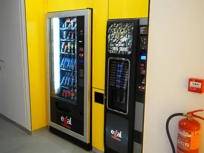 two vending machines are next to a wall at Pension Sarria in Sarria