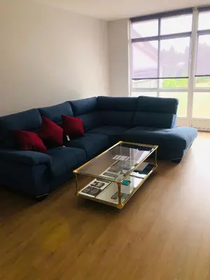 a blue couch in a living room with a coffee table at Casa Aricel VT in Chantada