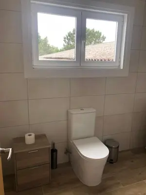 a white toilet in a bathroom with a window at Casa Aricel VT in Chantada