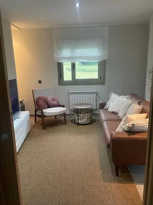 a living room with a couch and a chair at Apartamento en Barreiros in San Miguel de Reinante