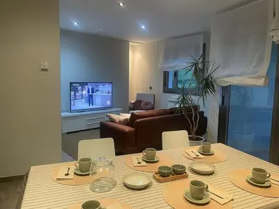 a living room with a table and a couch at Apartamento en Barreiros in San Miguel de Reinante