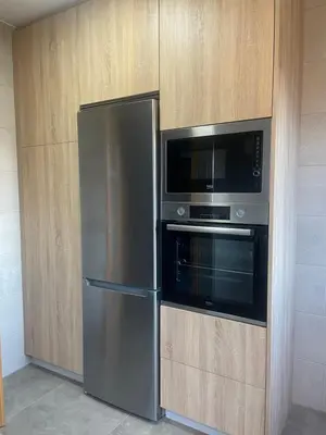 a kitchen with a stainless steel refrigerator and a microwave at Apartamento en Barreiros in San Miguel de Reinante