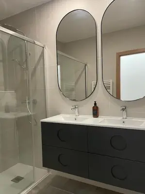a bathroom with a sink and a shower and a mirror at Apartamento en Barreiros in San Miguel de Reinante