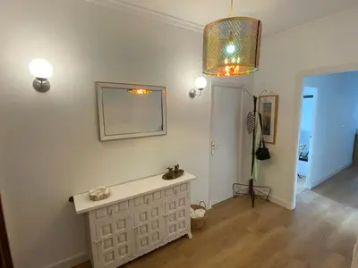 a living room with a table and a chandelier at Campo de la Compañía in Monforte de Lemos