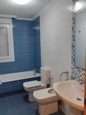 a bathroom with a toilet and a sink and a tub at ALVAFEr II in Ribadeo