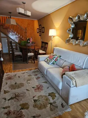 a living room with a couch and a dining room at Duplex Casa Camino in Ponferrada