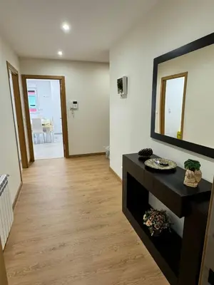 a living room with a large mirror on the wall at Cortiñas in Villalba