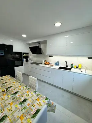 a kitchen with a table and a counter top at Cortiñas in Villalba