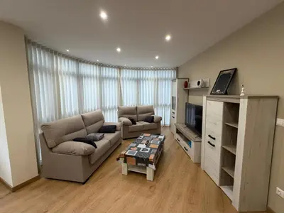 a living room with a couch and a table at Cortiñas in Villalba