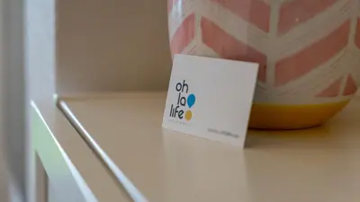 a sign sitting on top of a refrigerator at oh la life! at the top in Santiago de Compostela
