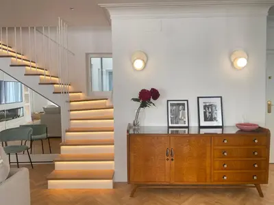 a staircase in a living room with a wooden dresser at oh la life! at the top in Santiago de Compostela