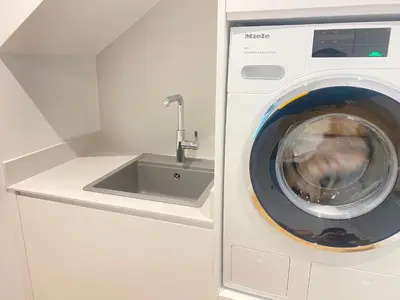 a washing machine in a kitchen with a sink at oh la life! at the top in Santiago de Compostela